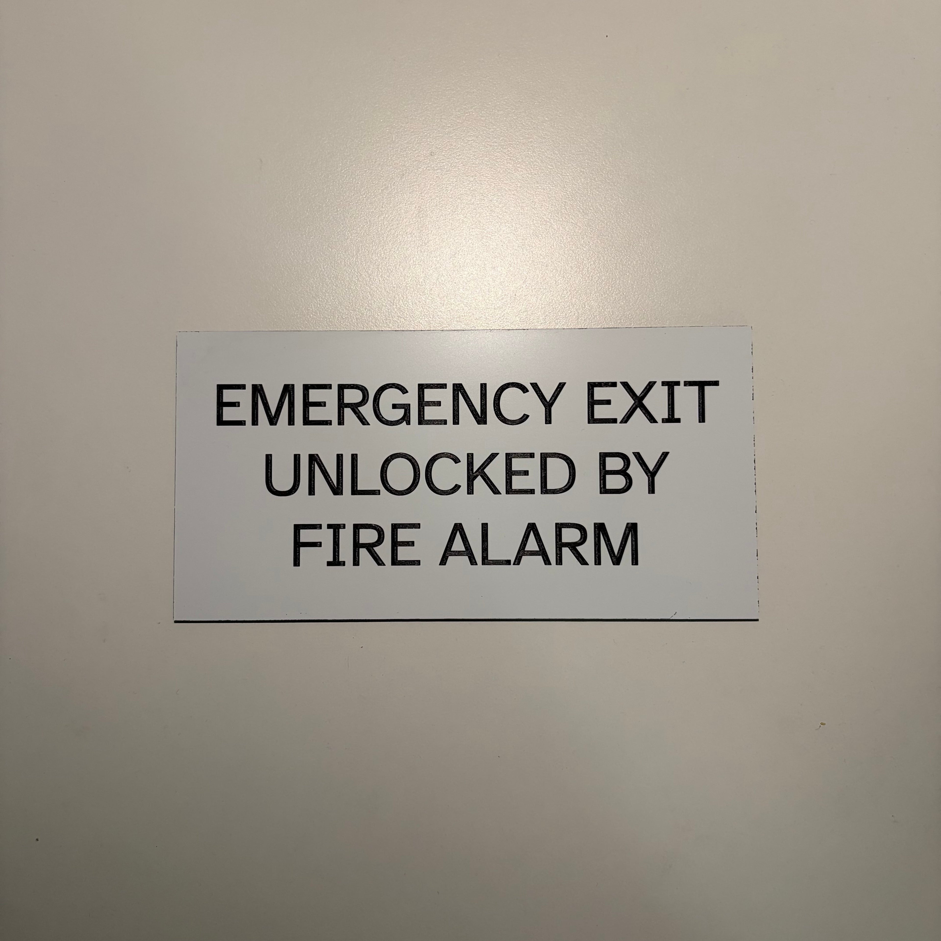 Emergency Exit Unlocked By Fire Alarm Sign 7"x3.5"